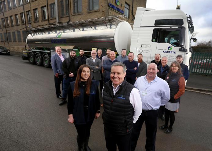 Oscrete Director Scott Wilson (front centre) is joined by the sales, lab and customer services teams at the company’s Bradford HQ to mark 40 years in business