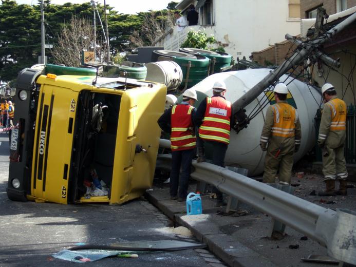 A concrete mixer truck on its side