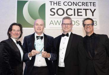 Four men holding an award