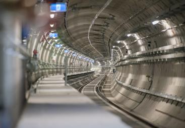 The inside of an under construction metro tunnel lined with precast concrete segments.