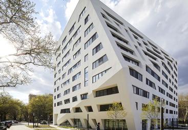 A white, 11 storey angular building
