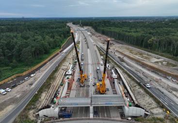 Two yellow cranes construct a new bridge