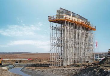 A bridge pier under construction covered in scaffolding