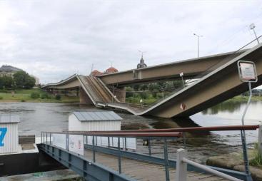 A side view of a collapsed road bridge