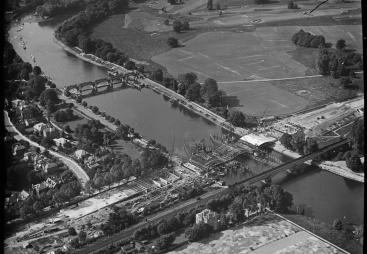 A black and white aerial photo of an under construction bridge