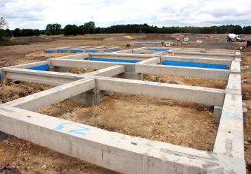 Concrete foundation beams for houses laid out on a construction site