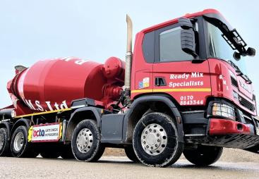 A bright red concrete mixer truck