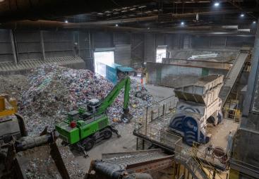 Inside SUEZ's recycling facility at Malpass Farm in Rugby, where Climafuel is produced in order to heat the kiln at Cemex's Rugby cement plant, a green material handler sorts waste