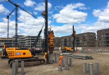 A yellow piling rig installing Precast Concrete Piles