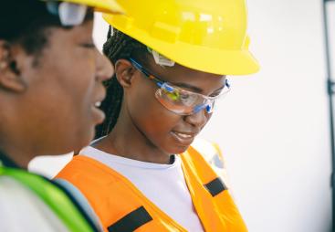 Two women in PPE.