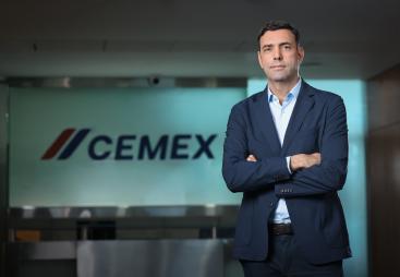 José Antonio Cabrera Cemex EMEA's new regional president stands with arms folded in front of a Cemex sign.
