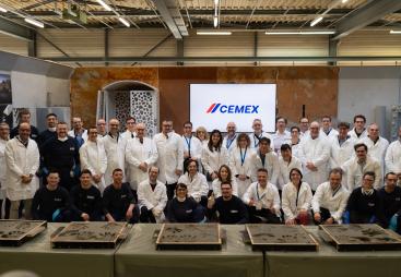 A group of people in white lab coats outside Cemex's GRD.
