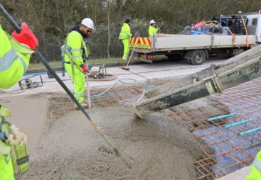 Men in PPE carry out repairs to the concrete road section of the M54