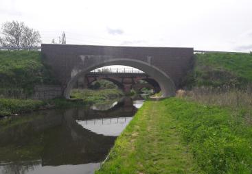 Three bridges - a new masonry clad bridge, with the original 18th century bridge and the new bridge seen through its span - on the River Ryton, in Nottinghamshire. Image: ABM Precast Solutions. 