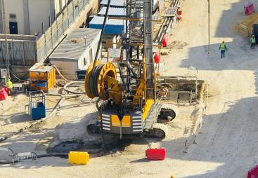 A view of a yellow Bauer piling rig at work on Cairo, Egypt's new metro station in Giza. In an estimated 14 months, Bauer Egypt will execute 209 diaphragm wall panels and 20 barrettes for Cairo's new metro station in the Giza district. Despite limited space and other challenges, work is progressing smoothly. Image: BAUER Group