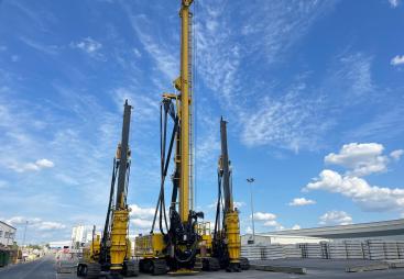 Three yellow piling rigs on a hard stand at RBL.
