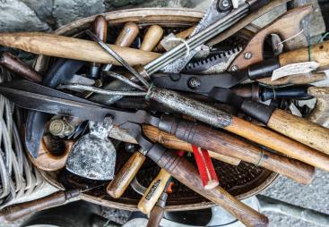 A bag of old hand tools with wooden handles