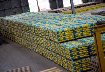 A pile of cement bags in a warehouse
