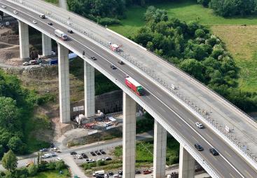 Workers monitor the precise hydraulic shift of the 40,000-tonne Rinsdorf viaduct, moved laterally into position in a German engineering first.
