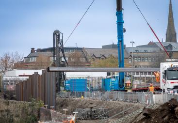 A blue piling rig installing sheet piles for the £4.4 million Rotherham Riverside upgrade