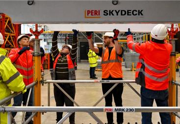 A group of PPE glad people receive formwork training from PERI UK, which delivers hands-on, accredited formwork training at its Brentwood facility and nationwide.