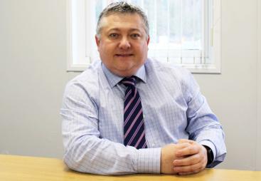 FPS chair Malcolm O’Sullivan sits at a desk facing the camera wearing a blue shirt and stripped tie. Malcolm has welcomed the £725bn infrastructure programme but warned of regulatory and workforce pressures.