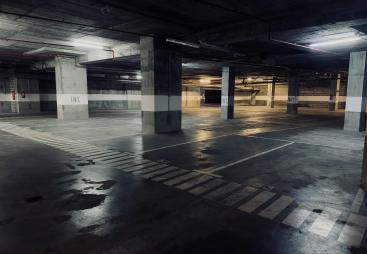 A dimly lit underground concrete carpark