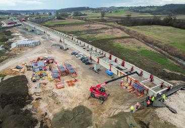 An under construction bridge in the countryside with construction machinery