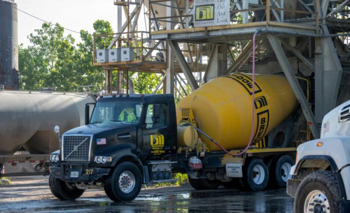 A blue and yellow concrete mixer truck