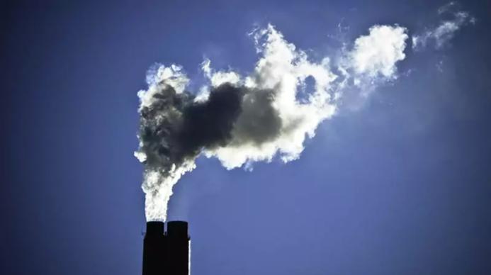 Smoke billowing out of an industrial chimney
