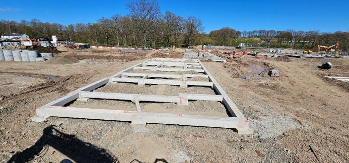 Concrete beams lying on the ground at a construction site