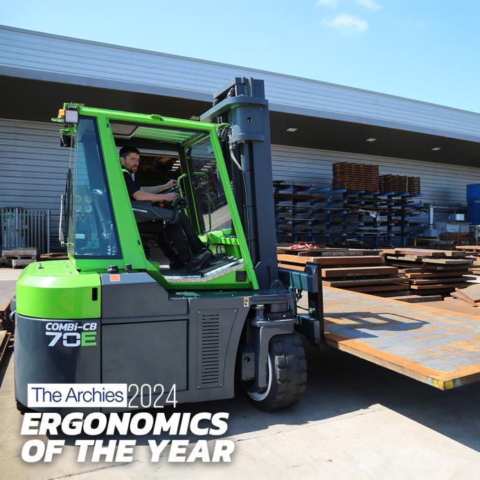 A green forklift outside a warehouse