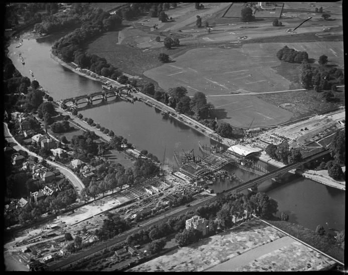 A black and white aerial photo of an under construction bridge