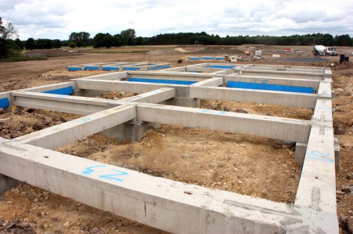 Concrete foundation beams for houses laid out on a construction site