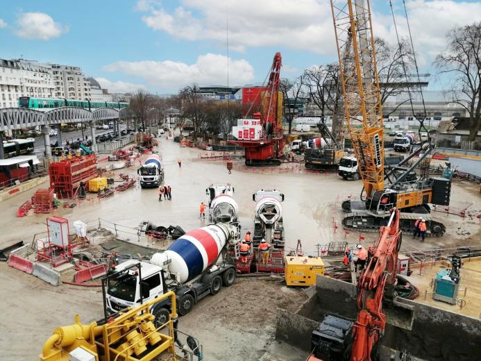 A crane, concrete mixer, excavator and other construction equipment helping pour concrete for the Austerlitz Basin in Paris
