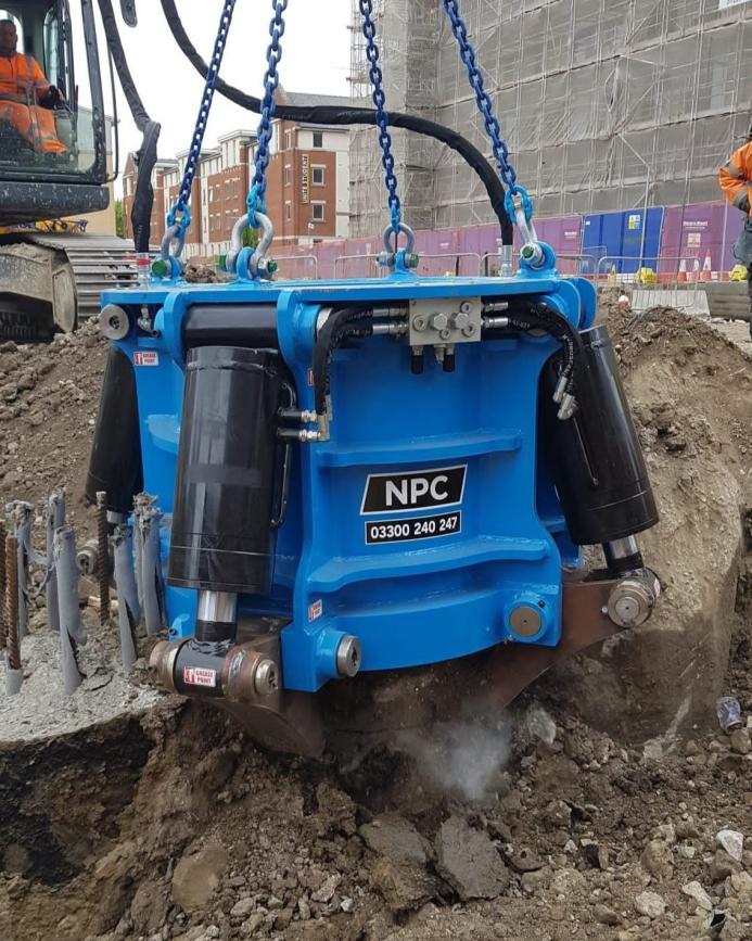 A close up of a blue pile cropper cutting a concrete pile