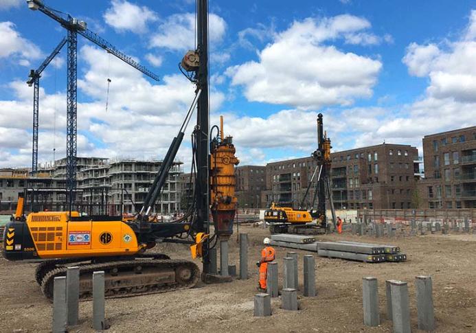 A yellow piling rig installing Precast Concrete Piles