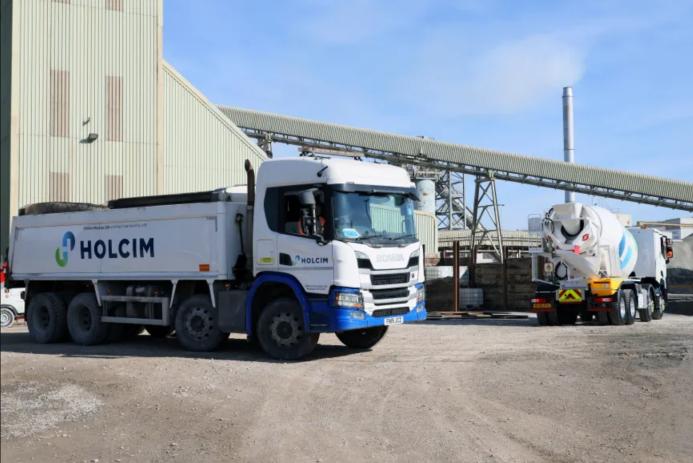 A white, Holcim branded truck at a cement works.