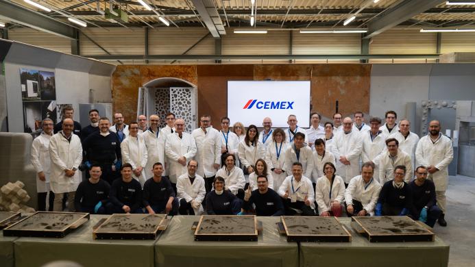 A group of people in white lab coats outside Cemex's GRD.