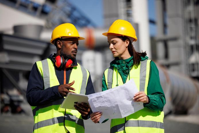 Construction workers in PPE talking