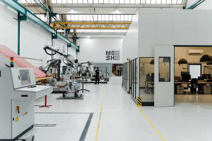In the hall, robots and humans work together under one roof.
