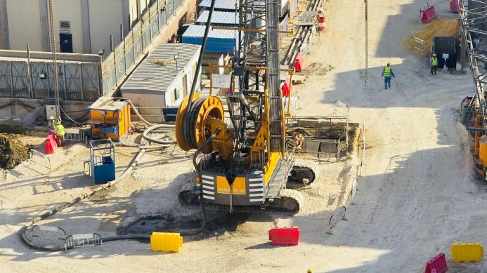 A view of a yellow Bauer piling rig at work on Cairo, Egypt's new metro station in Giza. In an estimated 14 months, Bauer Egypt will execute 209 diaphragm wall panels and 20 barrettes for Cairo's new metro station in the Giza district. Despite limited space and other challenges, work is progressing smoothly. Image: BAUER Group
