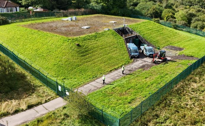 An aerial photo shows men in PPE and two vans at Stanley Hollowhouse following the installation of the cement-free, basalt-reinforced base for Scottish Water’s first verified Net Zero site.