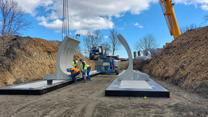 Concrete bridge elements are assembled