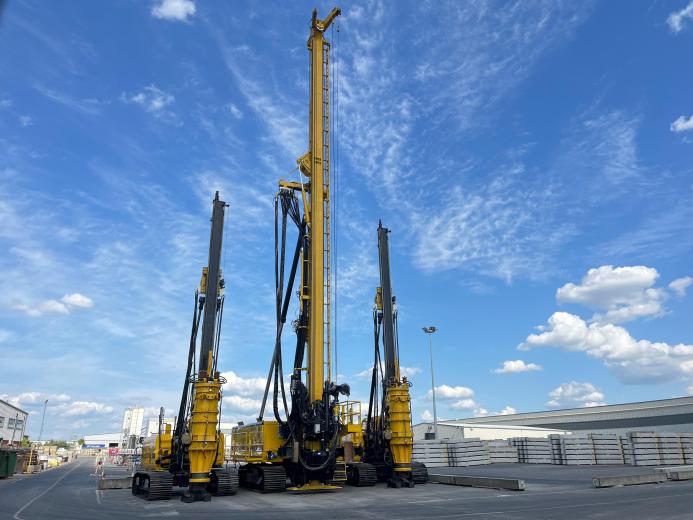 Three yellow piling rigs on a hard stand at RBL.