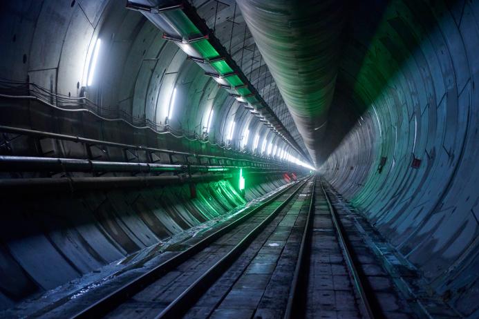 A diimly lit, concrete lined tunnel, Part of the newly completed westbound tunnel on the Italian side of the Brenner Base Tunnel. Over 400,000 precast segments will be used in total. (Image: Webuild)