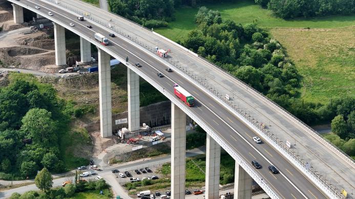 Workers monitor the precise hydraulic shift of the 40,000-tonne Rinsdorf viaduct, moved laterally into position in a German engineering first.