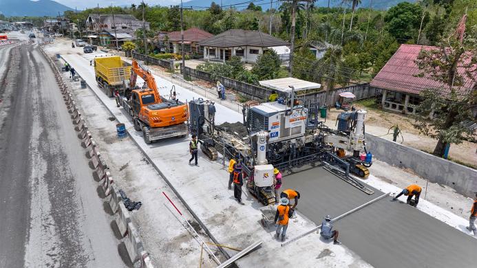 An aerial view of a road building project in Thailand showing Wirtgen’s SP 64 slipform paver installing reinforced concrete highways without the need for fixed formwork.