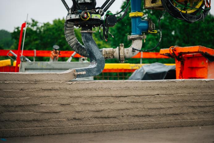 A concrete wall being 3d printed