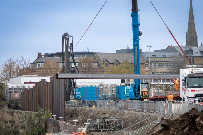 A blue piling rig installing sheet piles for the £4.4 million Rotherham Riverside upgrade